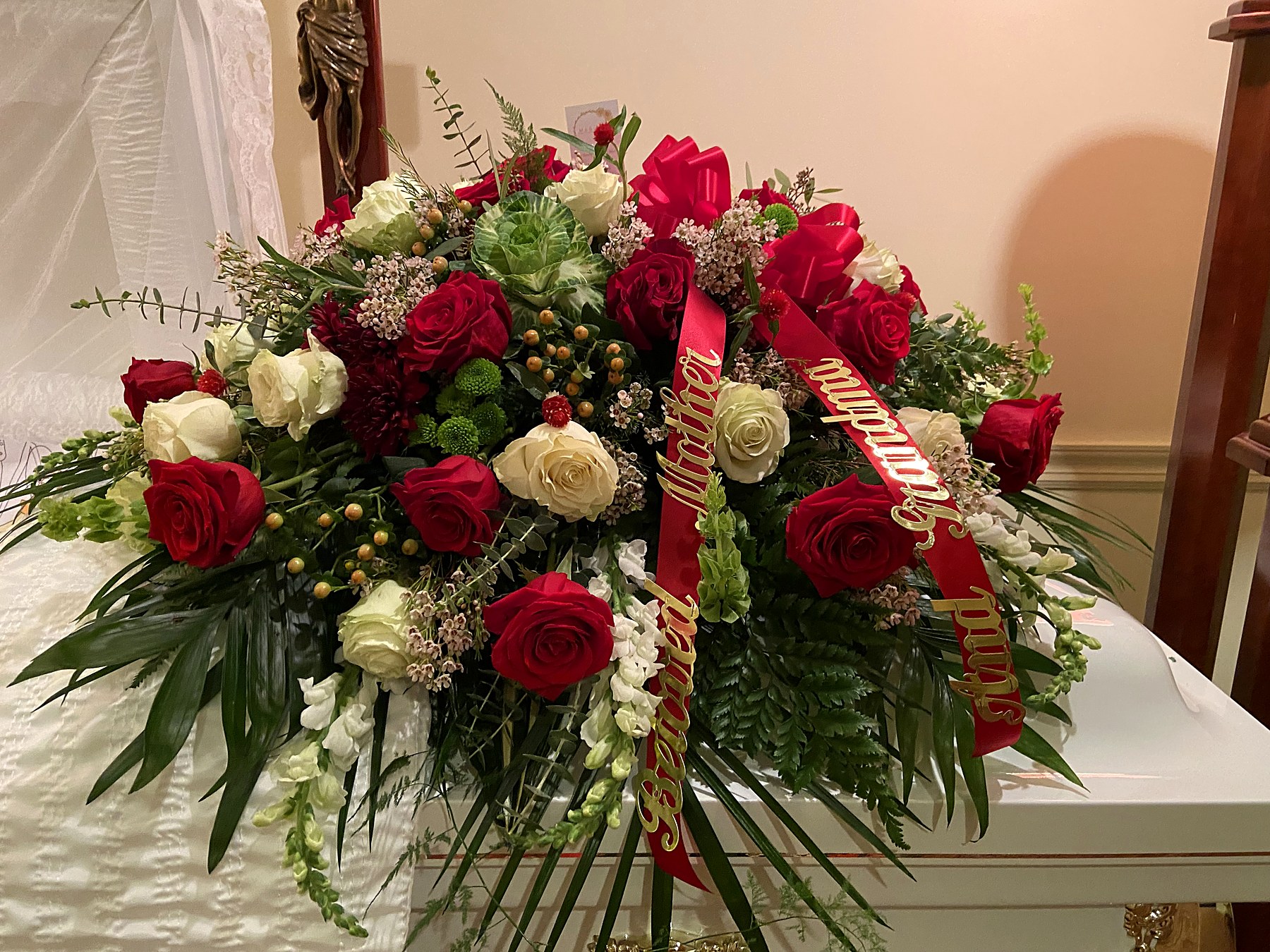 Casket spray of red and white roses with Mother and Grandmother ribbons