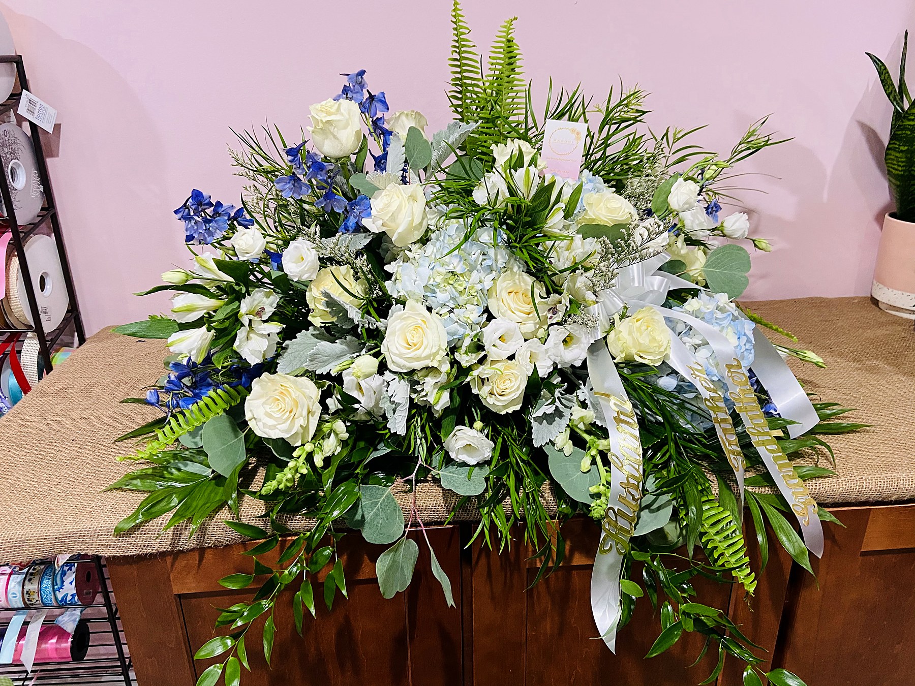 Table arrangement of white roses and blue accents
